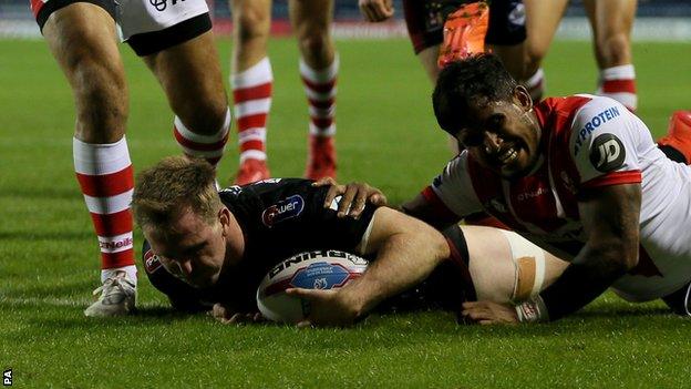 Dan Sarginson scores the first of his two first-half tries for Wigan against St Helens