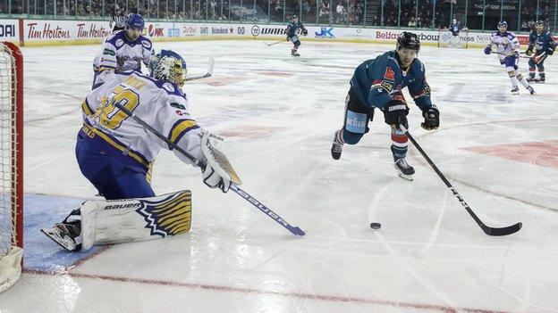 It's a race for the puck between Fife netminder Shane Owen and Scott Conway