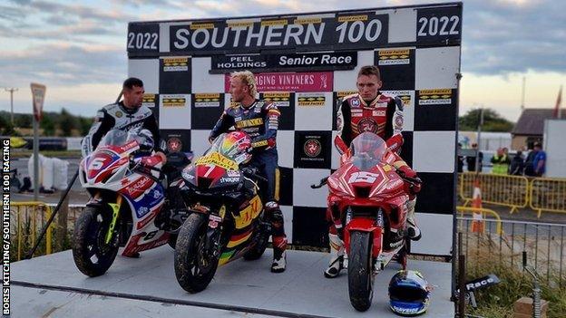 Top three riders with bikes on Southern 100 podium