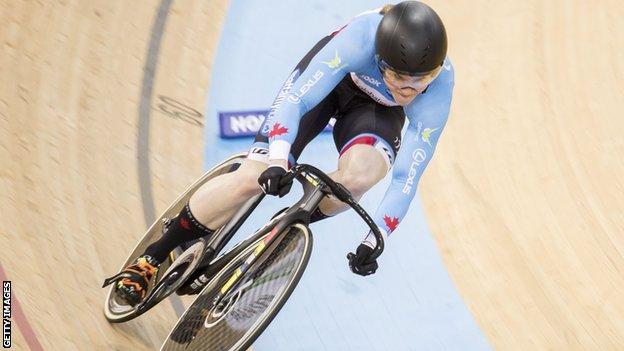 Kate O'Brien cycling in a velodrome