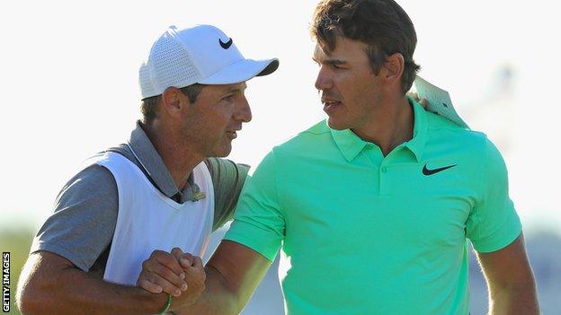 Caddie Ricky Elliott and Brooks Koepka embrace celebrate the US Open victory