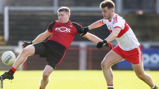 Down's Conor Maginn in action against Conor Nevin of Derry at Celtic Park