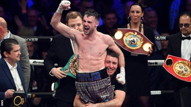 Josh Taylor celebrates victory after retaining all four world title belts