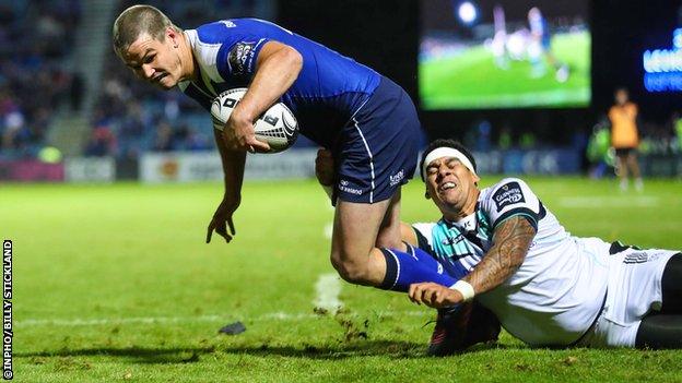 Johnny Sexton scores a try in the first half despite a tackle from Josh Matavesi