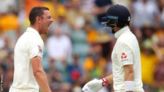 Josh Hazlewood celebrates taking the wicket of Joe Root