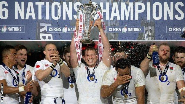 Captain Dylan Hartley holds aloft the Six Nations trophy after England's Grand Slam triumph in 2016