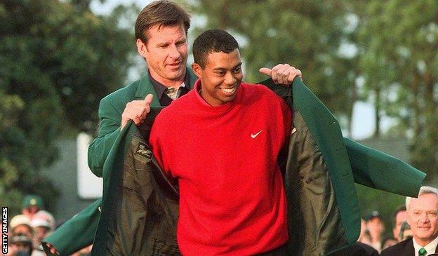 Nick Faldo hands Tiger Woods the Green Jacket at the 1997 Masters