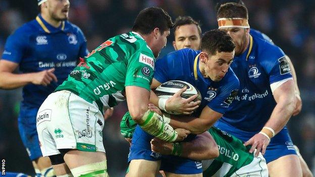 Noel Reid of Leinster is tackled by Benetton's Sebastien Negri