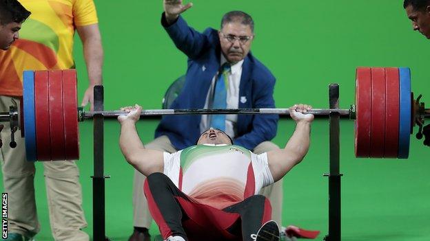 Iranian powerlifter Saman Razi lifts the bar