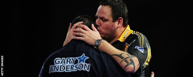 Gary Anderson is embraced by beaten finalist Adrian Lewis