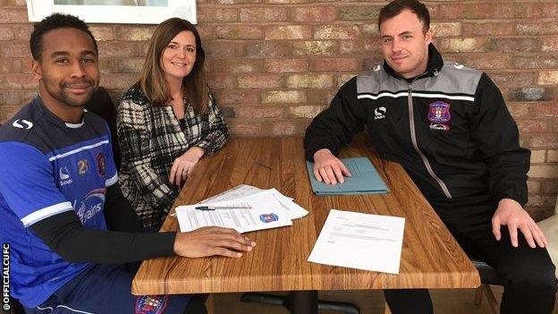 Louis Pedro signing terms with club secretary Sarah McKnight and head of recruitment Lee Dykes