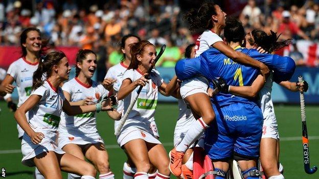 Spain players celebrate with goalkeeper Maria Ruiz after they beat Spain in a shootout