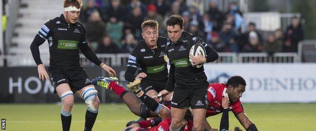 Lee Jones of Glasgow is tackled