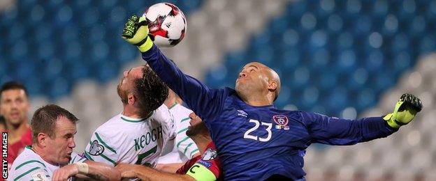 Darren Randolph attempts to punch away a cross in Belgrade