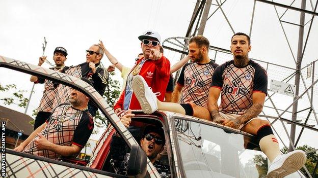 Newport County players model the new kit alongside members of Goldie Lookin' Chain