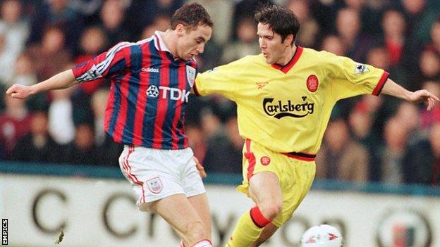 Jamie Fullarton (left) tackles Liverpool's Oyvind Leonhardsen