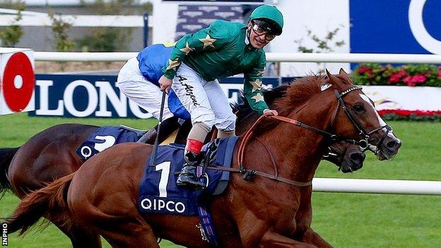 Andrea Atzeni shows his delight after guiding Decorated Knight to victory in the Irish Champion Stakes