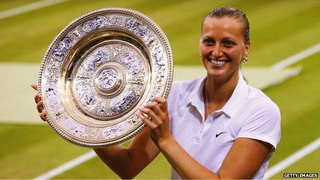 Petra Kvitova holds the the Venus Rosewater Dish trophy after her victory in the 2014 Ladies' Singles final