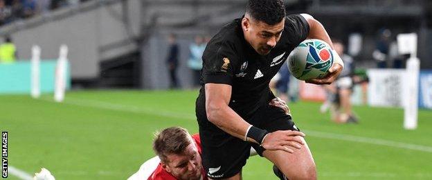 New Zealand scrum-half Richie Mo'unga scores despite Wales fly-half Dan Biggar's tackle