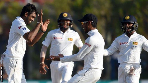 Sri Lanka's Dilruwan Perera (left) celebrates after taking a wicket against Australia