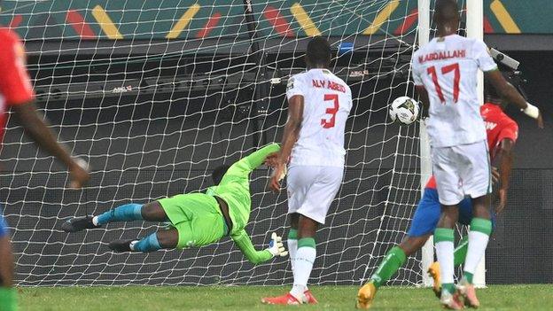 The Gambia's Ablie Jallow (hidden) wheels away in delight after his fine match-winner