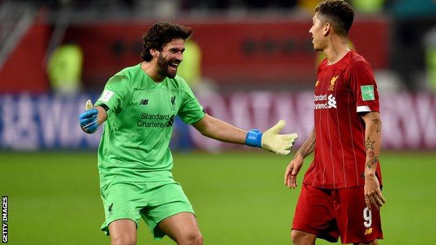 Alisson celebrates with Brazilian team-mate Roberto Firmino