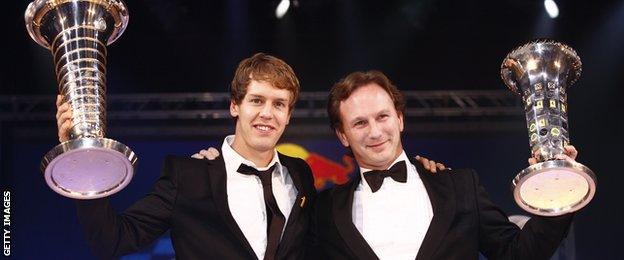 Sebastian Vettel and Christian Horner of Red Bull in 2010 collecting the Drivers and Constructors Championship trophies