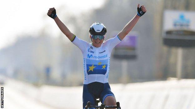 Dutch rider Annemiek van Vleuten raises her arms in celebration after winning the 2021 Tour of Flanders women's title