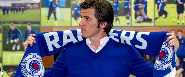 Joey Barton poses with a Rangers scarf after being presented to the media