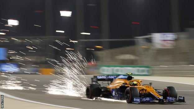 Sparks fly out of the rear of Lando Norris' McLaren