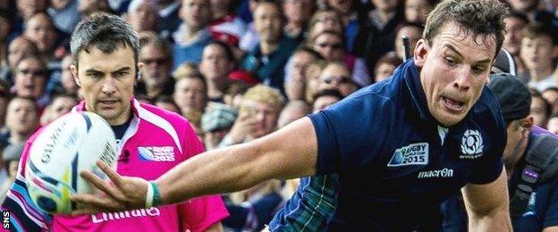 John Hardie offloads the ball against Japan at the World Cup