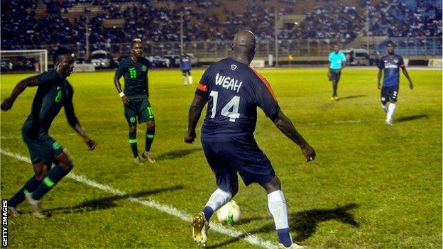 George Weah in action for Liberia at the age of 51