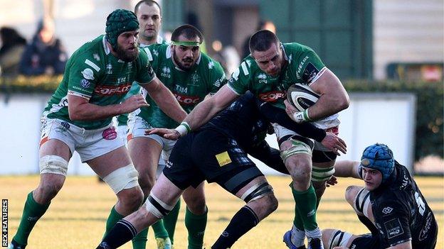 Abraham Steyn, the scorer of Benetton's third try, is tackled by Adam Ashe