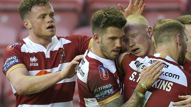 Joe Burgess, Oliver Gildart and Sam Tomkins celebrate Liam Farrell's try