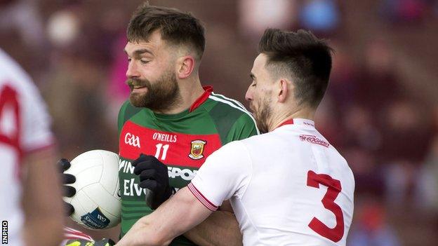 Padraig Hampsey battles with Mayo's Aidan O'Shea during a 2018 League match