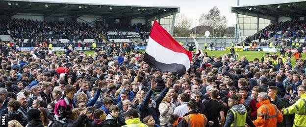 St Mirren fans celebrate their title win on the pitch at Paisley 2021 Stadium