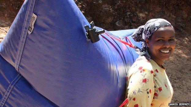 Ethiopian woman carrying a B-Energy balloon rucksack