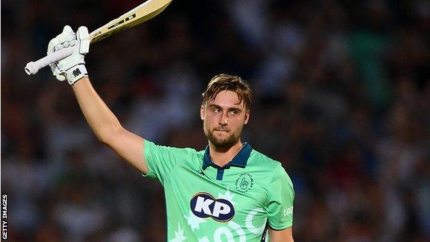 Oval Invincibles batter Will Jacks raises his bat to the crowd after hitting a century in The Hundred