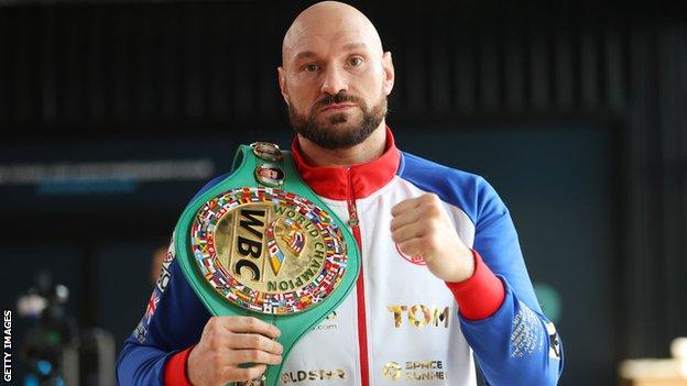 Tyson Fury poses with his WBC title