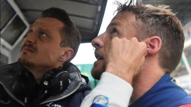 Jenson Button speaks to his team manager during the Le Mans 24 Hours race in 2018