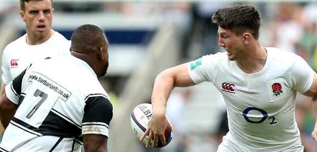 Tom Curry offloads for England against the Barbarians