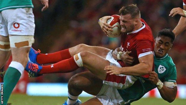 Wales debutant wing Owen Lane is tackled by Ireland centre Bundee Aki