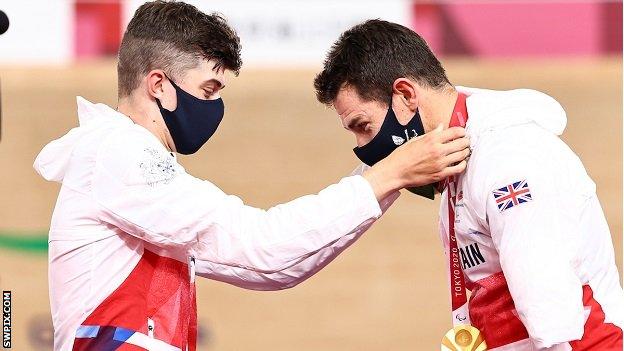 Fin Graham puts Jaco van Gass' gold medal around his neck