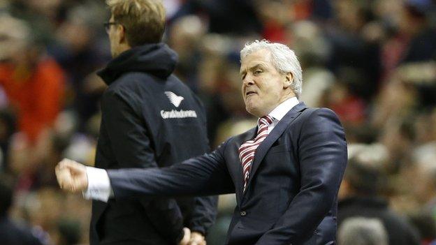 Stoke manager Mark Hughes celebrates his side's goal at Anfield