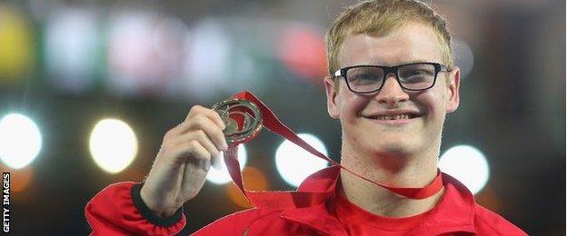 Rhys Jones shows off the bronze medal he won in the T37 100m final at the Commonwealth Games