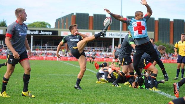 Rhys Webb clears during open training