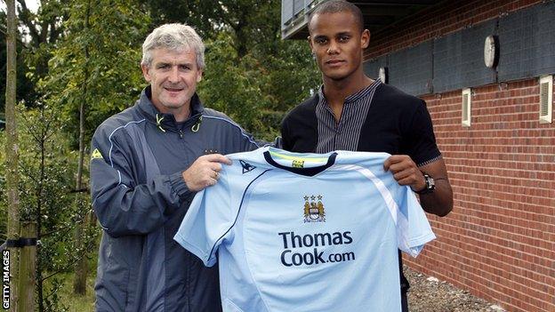 Manchester City Vincent Kompany with manager Mark Hughes