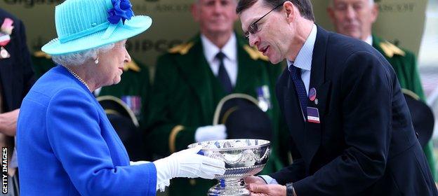 Aidan O'Brien receiving the leading trainer's trophy at Royal Ascot from The Queen