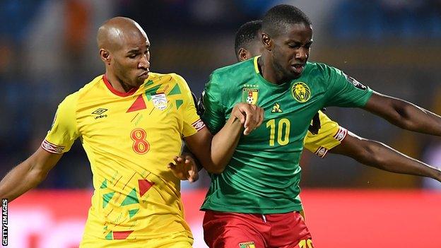 Benin's Jordan Adeoti challenges Cameroon's Arnaud Djoum