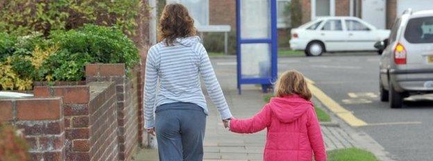 A mother walks with her daughter